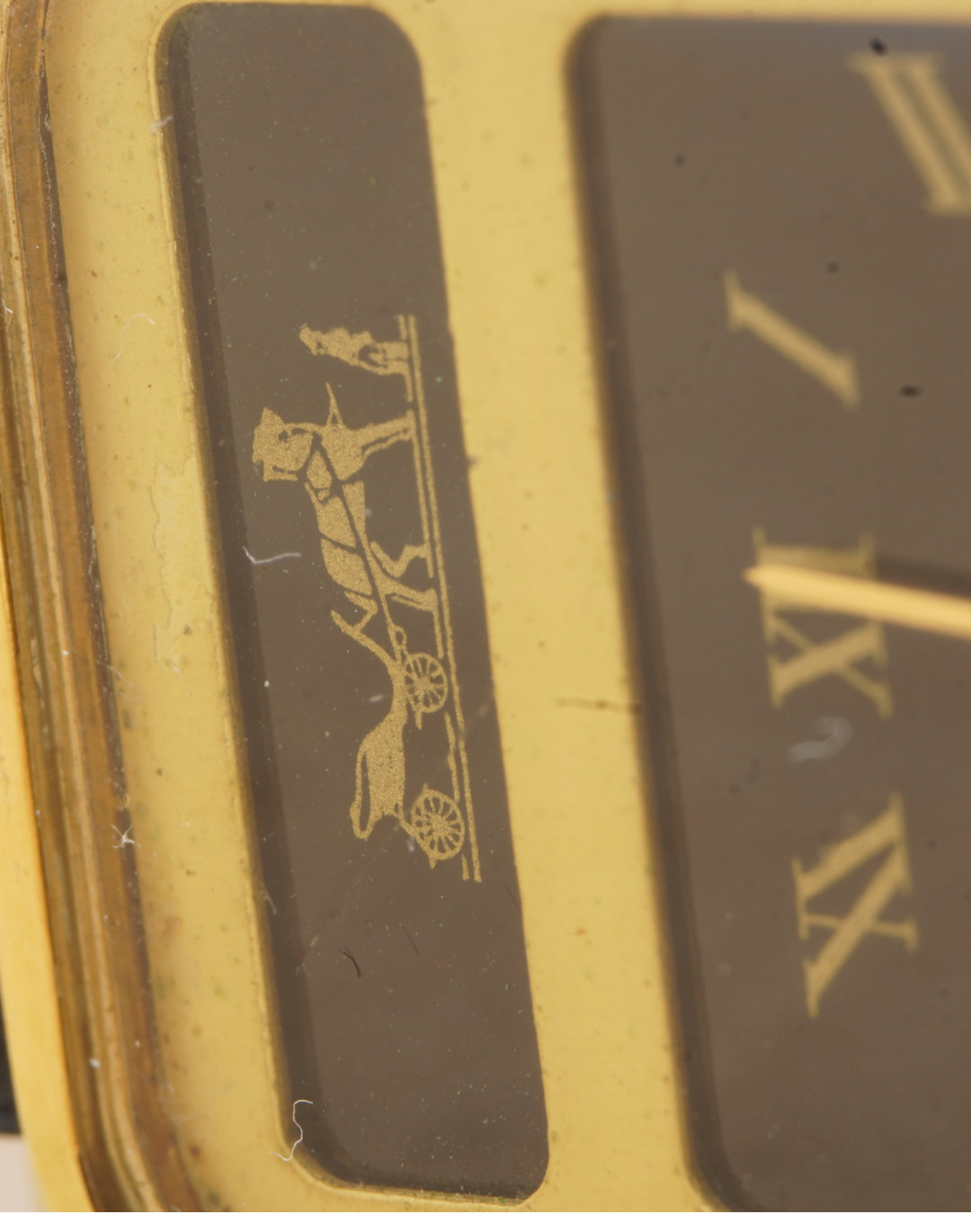 Hermès Calèche Rectangular — close-up of the carriage motif and dial